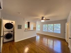 Little Rock apartment for rent - a living room with a washing machine and a ceiling fan