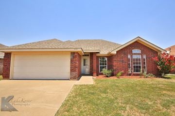 Abilene house for rent - A house with a garage door and a driveway.