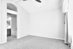 Ontario apartment for rent - A spacious room with a carpeted floor and a ceiling fan.