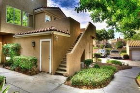 Ontario apartment for rent - A house with a brown stucco exterior and a red tile roof.