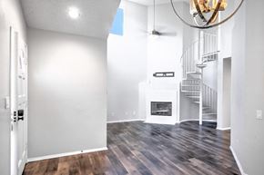 Ontario apartment for rent - A living room with a fireplace and a spiral staircase.