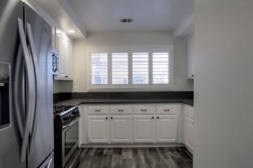 Ontario apartment for rent - A kitchen with white cabinets and a black countertop.