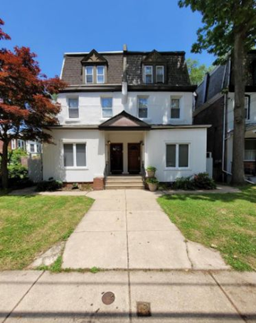 Philadelphia apartment for rent - a white house with a sidewalk in front of it