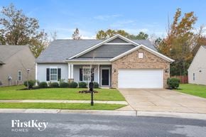 Charlotte house for rent - A house with a grey roof and a white garage door is shown.