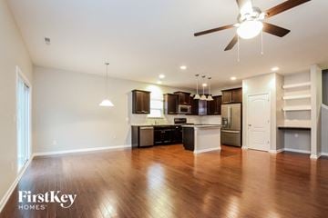 Charlotte house for rent - A spacious kitchen with wooden floors and a ceiling fan.