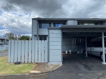 Mililani apartment for rent - A grey building with a white car parked in front.