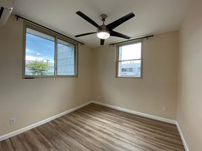 Mililani apartment for rent - A room with a ceiling fan and two windows.