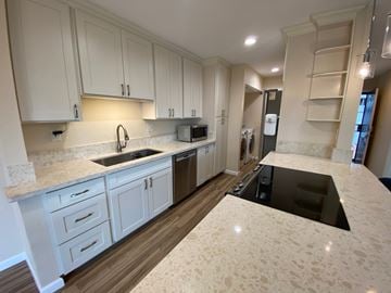 Mililani apartment for rent - A kitchen with white cabinets and a sink.