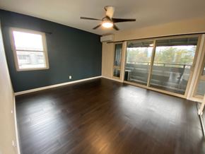 Mililani apartment for rent - A room with a ceiling fan and sliding glass doors.