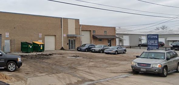 Dallas apartment for rent - A parking lot with a building and cars in front.