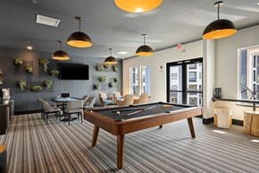 Independence apartment for rent - a clubhouse with a pool table and a tv