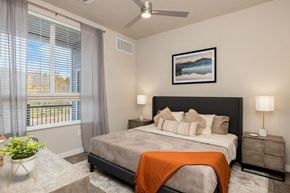 Independence apartment for rent - a bedroom with a bed and a ceiling fan