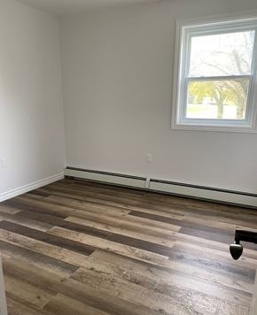 Kentville apartment for rent - A room with a window and a wooden floor.
