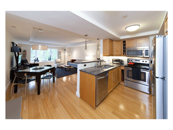 Maple kitchen cabinetry with striking limestone and quartz countertops