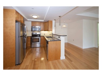 Stylish maple cabinetry in kitchens with laminate, wood trimmed countertops