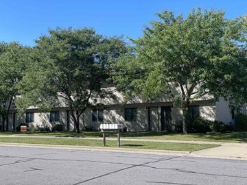 Onalaska apartment for rent - A row of houses with trees in front.
