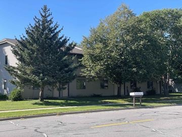 Onalaska apartment for rent - A tree stands in front of a house.