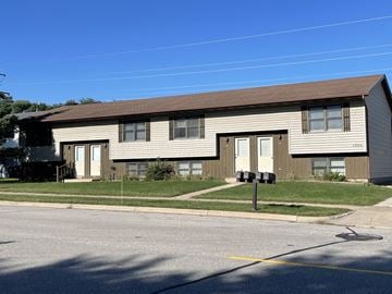 Onalaska apartment for rent - A two-story residential building with a brown roof and beige siding.
