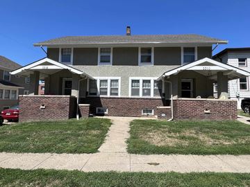 Omaha apartment for rent - a large house with a sidewalk in front of it