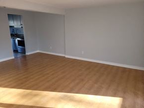 Waterloo apartment for rent - an empty living room with a wooden floor