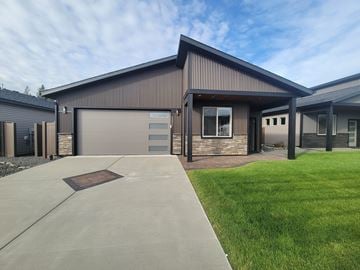 Rathdrum house for rent - the front of a house with a driveway and a garage door