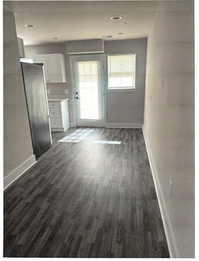 Laurel apartment for rent - A kitchen with a refrigerator and a door leading outside.