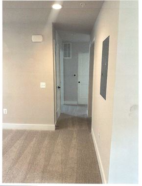 Laurel apartment for rent - A hallway with a door at the end.