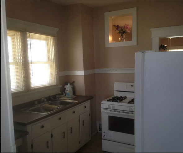 Saint Louis house for rent - a kitchen with a stove and a sink and a refrigerator