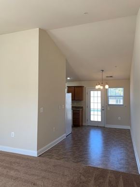 Laurel apartment for rent - A room with a kitchen area in the background.