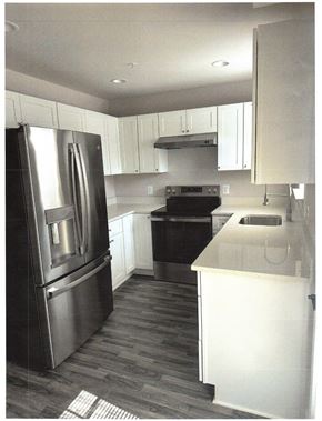 Laurel apartment for rent - A kitchen with a black fridge and stove.