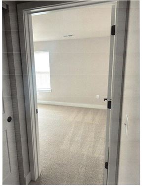 Laurel apartment for rent - A white door is open to a room with a carpeted floor.