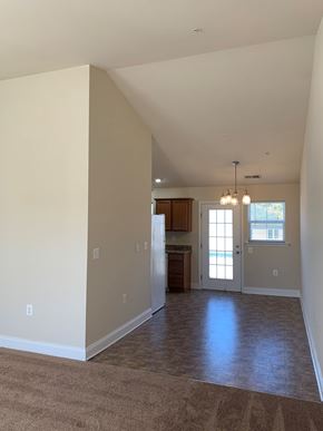 Laurel apartment for rent - a empty living room with a kitchen in it