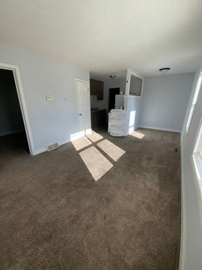 Fremont apartment for rent - A room with a carpeted floor and a white door.