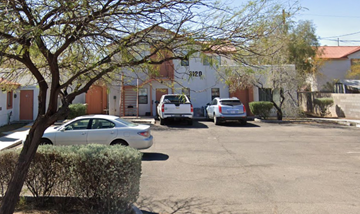 Tucson apartment for rent - A parking lot with cars and a building with the number 3120.