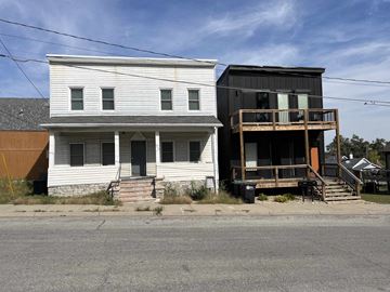 Omaha apartment for rent - a white house and a black house on the side of a street