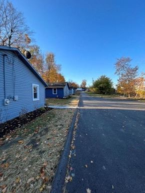 Medina house for rent - A blue house with a driveway and trees in the background.