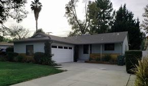 Woodland Hills apartment for rent - A house with a garage and a driveway.