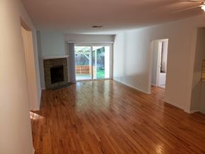 Woodland Hills apartment for rent - A room with wooden floors and a fireplace.