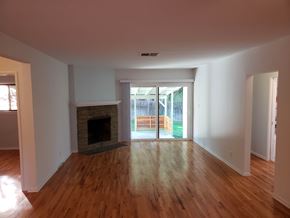 Woodland Hills apartment for rent - A room with a fireplace and wooden floors.