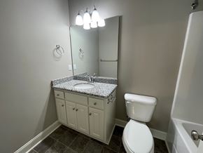 Wilson apartment for rent - A white toilet sits next to a sink in a bathroom.