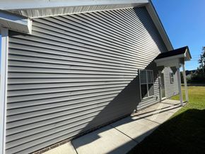 Wilson apartment for rent - A house with a grey siding and a white roof.