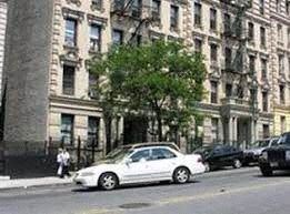 New York apartment for rent - A white car is parked on the side of a street.