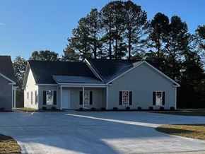 Wilson apartment for rent - a white house with a driveway and trees