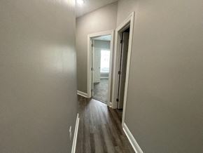 Wilson apartment for rent - a hallway with a doorway to a bedroom and a door to a bathroom