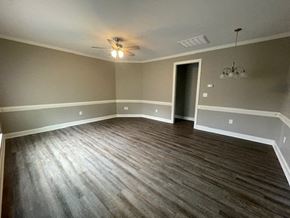 Wilson apartment for rent - an empty living room with a ceiling fan
