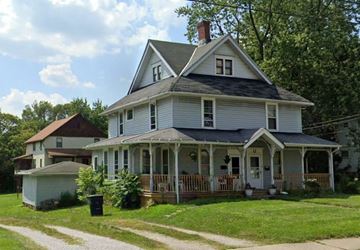 Wadsworth apartment for rent - A two-story house with a porch and a chimney.
