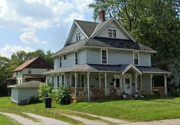 Wadsworth apartment for rent - A two-story house with a porch and a chimney.