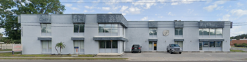Winter Park apartment for rent - a large white building with cars parked in front of it