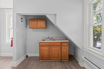 Philadelphia apartment for rent - A kitchen with wooden cabinets and a window.