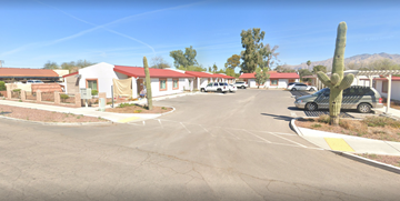 Tucson apartment for rent - a parking lot in the middle of a street at a motel